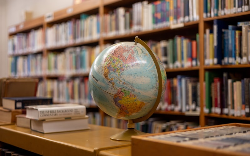 A globe sitting on a table in a library