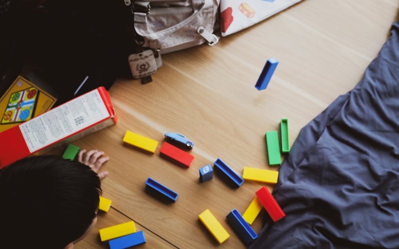 Child playing with colorful building blocks